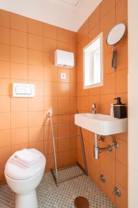 a bathroom with a toilet and a sink at Sweet Bright Flats - City Center in Porto