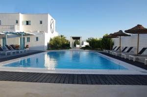 a swimming pool in front of a building at Villa Markezinis in Perivolos