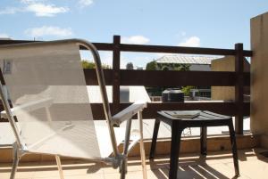 a chair and a table on a balcony at La Brisa in Mar del Plata