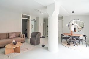a living room with a couch and a table at Stylish Ground Floor Flat Perfect for Couples in Copenhagen