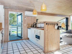 a kitchen with a counter and a stove top oven at 8 person holiday home in Juelsminde in Sønderby