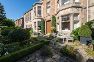 a garden in front of a large brick building at St Colms Main House in North Berwick