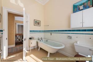 a white bathroom with a tub and a sink at St Colms Main House in North Berwick +50 photos