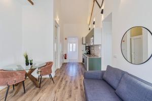 a living room with a couch and a table and a mirror at Design Setubal in Setúbal