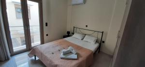 a bedroom with a bed with a towel on it at AYRA ROOMS ALIVERI in Aliveri