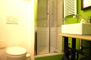 a bathroom with a shower and a toilet and a sink at B&B Loft Padova in Padova