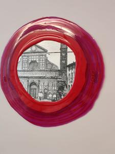 a red hula hoop with a drawing of a building at ECOZYHOUSE in Florence