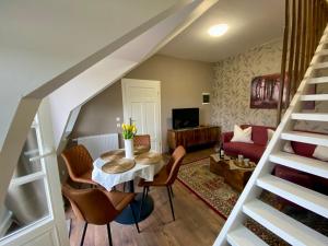 a living room with a table and chairs at Ferienhaus Ostrauer Hof in Bad Schandau