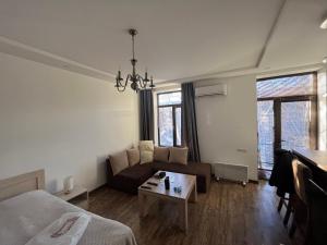 a living room with a couch and a table at Cascade White Luxury Apartment in Yerevan