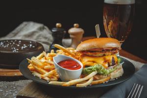 a plate with a sandwich and french fries and ketchup at Wellton Centrum Hotel & SPA in Riga +46 photos