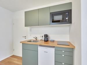 a kitchen with a sink and a microwave at Humboldt41 in Nuremberg