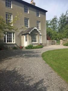 a house with a gravel driveway in front of it at Top Floor at Cantref House in Brecon