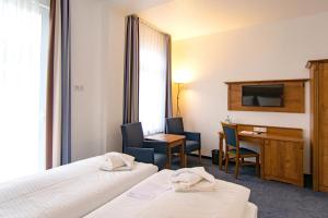 Postel nebo postele na pokoji v ubytování Hotel am Fischerstrand