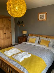 a bedroom with a bed with towels on it at Top Floor at Cantref House in Brecon