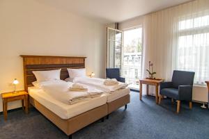 Postel nebo postele na pokoji v ubytování Hotel am Fischerstrand