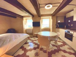 Schlafzimmer mit einem Bett, einem Tisch und Stühlen in der Unterkunft Coast 52 Savynomad Harbour Residences wow Views in Valletta