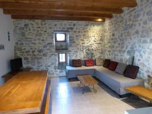 a living room with a couch and a table at La Bastide des Borels in Berrias Et Casteljau