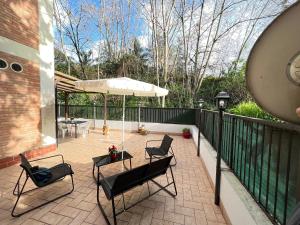 a patio with two chairs and an umbrella at Vatican Flat Cozy with Terrace in Rome