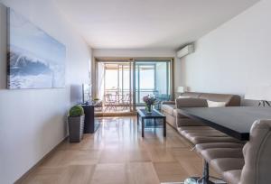 a living room with a couch and a table at SEA FRONT - panoramic sea view studio with terrace in Nice