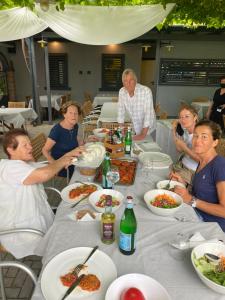 a group of people sitting around a table eating food at Casa vacanze Girardi in Gorizia