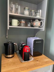 a coffeemaker and a toaster sitting on a shelf at The Green Room guest suite in Belfast