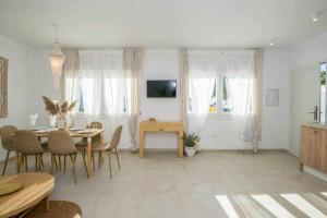a living room with a dining room table and chairs at Marinero beach 1 in Torrox Costa
