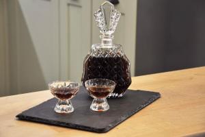 a bottle of whiskey and two glasses on a table at ChrysaMare Luxury living Ολόκληρη κατοικία in Afissos +71 photos