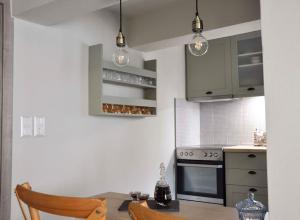a kitchen with a table and a stove top oven at ChrysaMare Luxury living Ολόκληρη κατοικία in Afissos