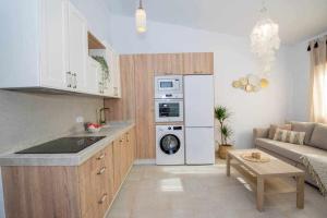 a kitchen with a white refrigerator and a living room at Marinero beach 3 in Torrox Costa