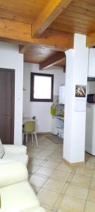 a living room with white walls and a wooden ceiling at Il Ghiandolino in Imola