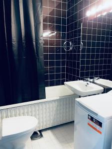 uma casa de banho com um WC, um lavatório e uma banheira em Tapiola Center Apartment em Espoo