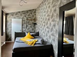 a bedroom with two beds and a stone wall at Altstadtpension am Dom in Erfurt