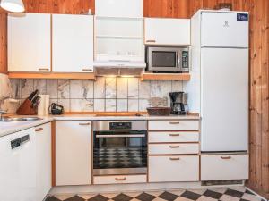 a kitchen with white cabinets and a stove top oven at 8 person holiday home in Juelsminde in Sønderby