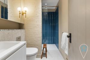 a bathroom with a toilet and a sink at Modern 1BR home in Islington! in London