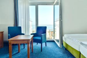 Postel nebo postele na pokoji v ubytování Hotel am Fischerstrand
