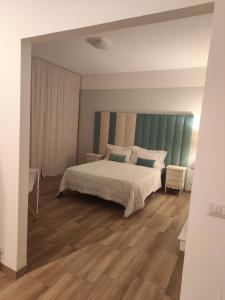 a bedroom with a bed and a wooden floor at Villa Cresto in Gaglianico +16 photos