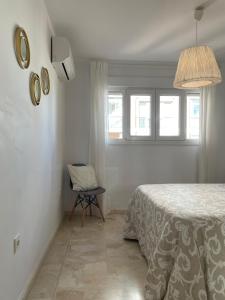 A bed or beds in a room at Malagadevacaciones - La Marea