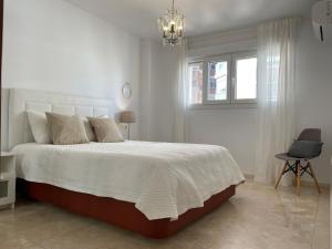 A bed or beds in a room at Malagadevacaciones - La Marea