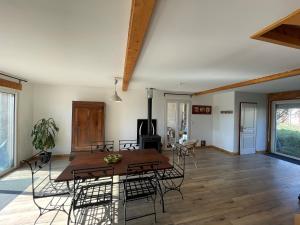 a dining room and living room with a table and chairs at Terres de Barréjat in Cazals-des-Baylès