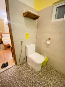 a small bathroom with a toilet and a shower at Three Jewels Boutique Hotel in Pokhara