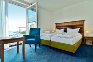 Postel nebo postele na pokoji v ubytování Hotel am Fischerstrand