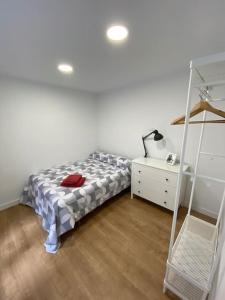 a bedroom with a bed and a dresser and a shelf at Santander Jiménez Díaz 7B in Santander
