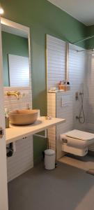 a bathroom with a sink and a toilet at Rental house in Dumbrăviţa