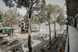 a view of a city street with a tree at Stay&Chill - H.3 - Spacious loft near Ben Thanh in Ho Chi Minh City