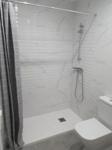 a white bathroom with a shower and a toilet at Modern & sunny apartment near Valencia in Paiporta