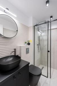 a bathroom with a black sink and a shower at Spectacular Apartment - 4BR-Terrace - Piata Romana in Bucharest