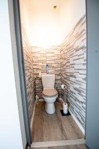 a bathroom with a toilet in a room at Aux portes de Lyon Tout confort emplacement idéale Netflix in Givors