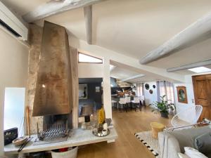 a living room with a large stone fireplace at Au rep&egrave;re d'Argante in P&eacute;zenas