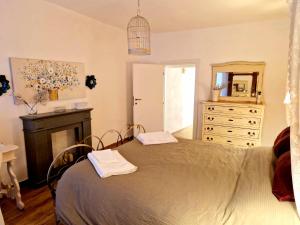 a bedroom with a bed and a dresser and a mirror at La Casa di Livia in Trevignano Romano