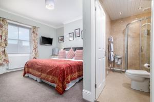 a bedroom with a bed and a shower and a toilet at Bramblewick in Whitby